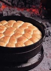 Cast Iron dutch oven cooking on coals
