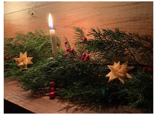 Christmas candle and greenery on mantle