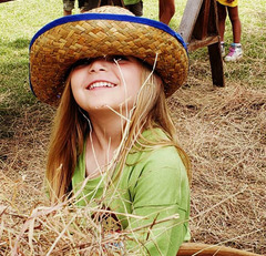 Will Rogers Wild West Camp collage of children bailing hay, hammering nails, practicing lassoing, washing clothes on a washboard