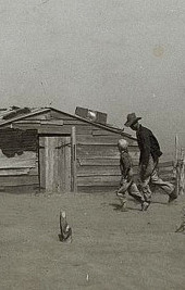 Dust Bowl photograph of Arthur Cole and son walking toward their home in the midst of a Dust storm in 1936