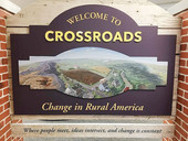 Crossroads exhbiit entry panel with landscape photo of rural America