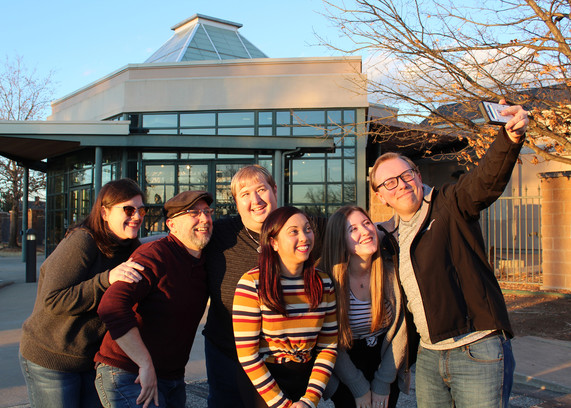 A group of people in front of the Cherokee Strip Regional Heritage Center taking a selfie