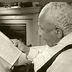 Otis Clark reading a newspaper
