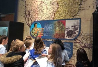 a photo of children at the Oklahoma History Center looking at exhibit displays "Complimentary Mondays" is the heading