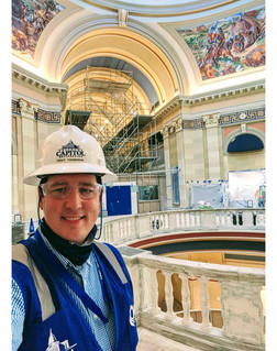 Trait Thompson, wearing a hard hat, selfie taken at the Oklahoma State Capitol