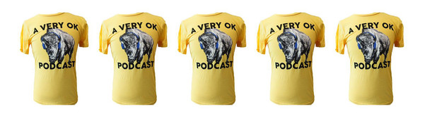 A line of A Very OK Podcast t shirts. The clothing item is yellow with the podcast logo featuring a bison with headphones