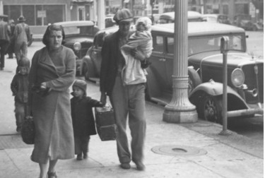 A poverty stricken family walk the streets of Oklahoma City in 1937