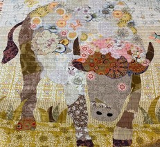 A quilt pieced with the figure of a bison