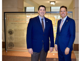 OHS Executive Director Trait Thompson and Lt. Governor Pinnell stand in front of the Oklahoma State Capitol exhibits