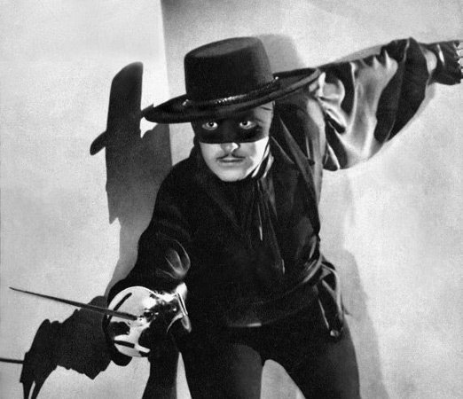Douglas Fairbanks wearing a mask and leading with a sword in the Silent Film "Zorro"