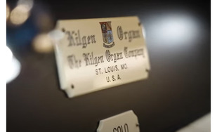A detail of the Kilgen organ metal plate label, with the manufacturer's town St. Louis