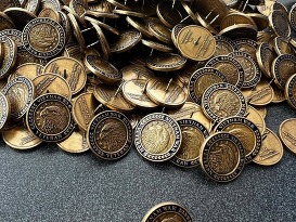a bunch of Vietnam War–era pins are collected on a table top