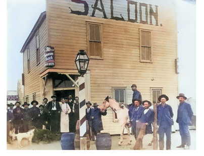 A period photograph of a NW Oklahoma Saloon. Men are standing outside, some on horseback to have their photo taken, c. 1880s