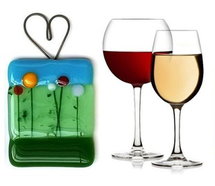 Wine glasses and a glass fusion suncatcher with a meadow and sky motif
