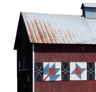 A red barn with wooden quilt pattern design