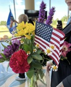 A bouquet of flowers with a small flag at the center