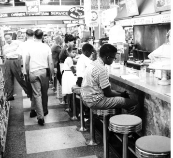 Ayanna Najuma, age 7, looking directly at the camera, participating in the Katz Drug Store sit-in