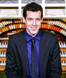 Zach Frame seated at a large pipe organ