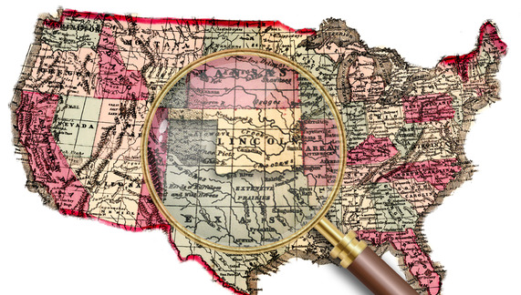 An 1864 map with a magnifying glass focused in the Great Plains, specifically on the state of Oklahoma hear labeled as "Lincoln."