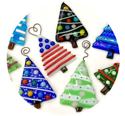 Colorful glass Christmas tree ornaments in random order made with a variety of designs in green, red, blue, and other colors.