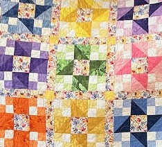  A multicolored "Friendship Star" quilt with a star pattern and a mix of calico fabrics