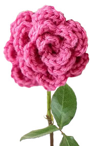 A crocheted flower made of deep pink yarn superimposed on a real rose stem.