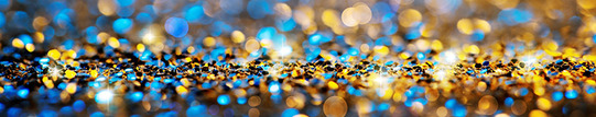 Confetti falling in gold and blue colors with some areas of sparkle. Confetti is gathered at the bottom of the image