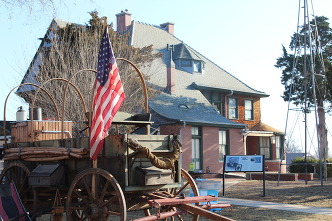 A Chuck Wagon with an American flag situated on the grounds of the Horizon Hill Mansion in Kingfisher Oklahoma