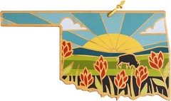 a cutting board with flowers and bison decoration. The cutting board is in the shape of the State of Oklahoma