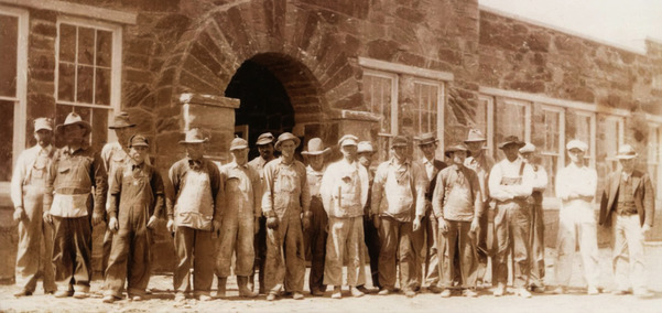 Photograph of old Valliant High School under construction in 1936. Built by WPA workers who are standing outside of the building.
