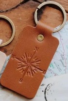 Compass Key Chain made of leather. The compass is stamped on the leather