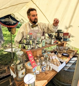 Sutler's Store merchant lining his goods up in a tent