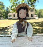 Farmer dave doll at the gates of Hunter's Home. The house can be seen behind the figure