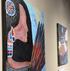 A painting featured in the exhibit "From Our Hands" that pictures a wall of paintings.