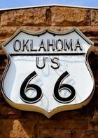 Route 66 sign on a sandstone building