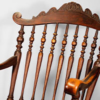 An antique woman's dress and rocking chair, depicted in detail