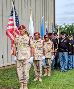 Veterans lined up at the Honey Springs Battlefield with flags in hand during the Battle of Honey Springs memorial service held in July