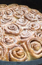 Cinnamon Rolls cooked in a cast iron cooking vessel