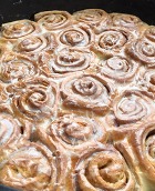 Cinnamon Rolls cooked in a cast iron cooking vessel