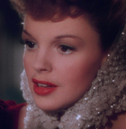 a still from the 1944 movie "Meet Me in St. Louis" depicting Judy Garland singing at a window