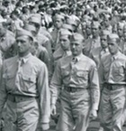 World War II soldiers march past a crowd in a parade formation, 1940s