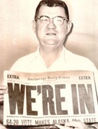 A man holds a newspaper with large lettering that reads "We're In: 64-20 vote makes alaska 40th State" August 2, 1961