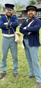 Living History soldiers in their reenactment uniforms stand within the Fort Gibson Stockade