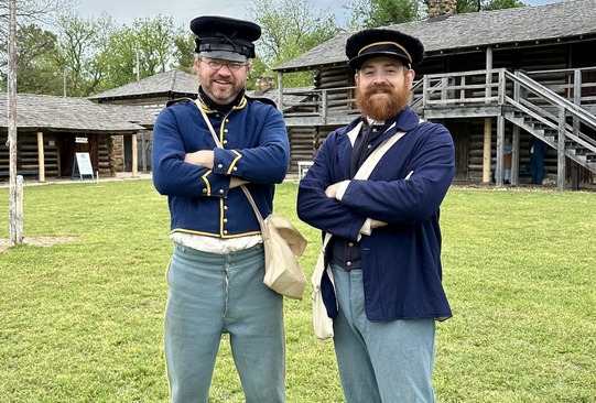 Living History soldiers in their reenactment uniforms stand within the Fort Gibson Stockade