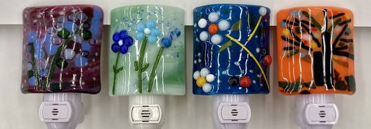 A series of glass nighlight covers, all made from glass with a variety of designs and colors