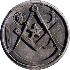 An image of a Mason's gravestone with symbols like the sun, crescent moon, and compass engraved in the grey stone