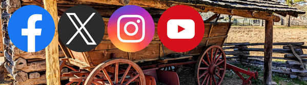 A Conestoga Style Wagon underneath a  log cabin shelter with Social Media icons in the foreground