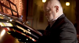 Organist Dennis Scott playing an organ