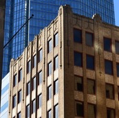 A building in downtown Oklahoma City with a skyscraper in the background