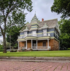 The Fred and Addie Drummond Home photo taken by Trait Thompson. A three story Victorian home with a pointed tower atop